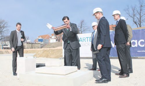 Zur Grundsteinlegung mauerte der geschäftsführende Gesellschafter Markus Rustler (mitte) gemeinsam mit Geschäftspartnern die Zeitkapsel ein. Foto: Pohl