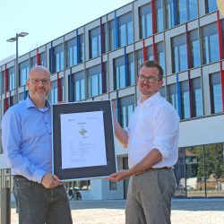 StESAD-Chef Axel Walther und Baubürgermeister Raoul Schmidt-Lamontain (r.) sind stolz auf die Auszeichnung für das nachhaltige Bauen für den Schulcampus Tolkewitz. Foto: Pohl